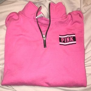 PINK quarter-zip sweatshirt.
